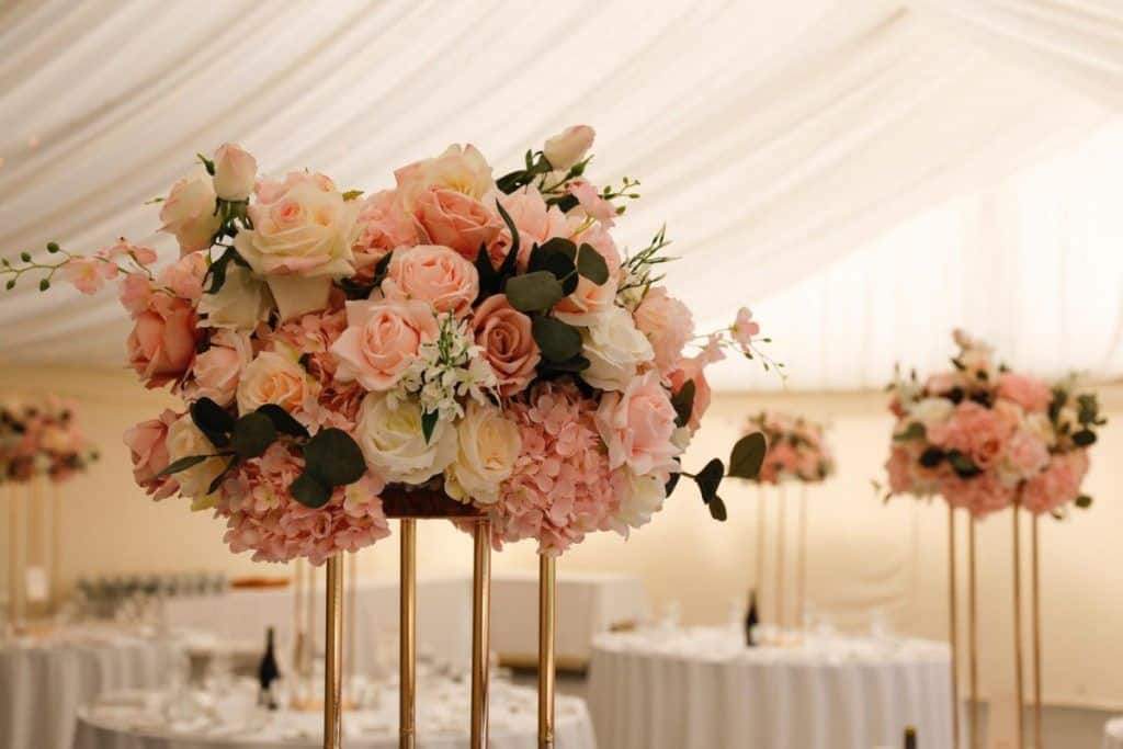 A large tent with beautiful floral decorations available for hire.