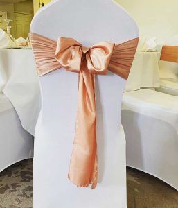 white chair cover and silk sash