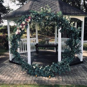 A gazebo adorned with floral decorations.