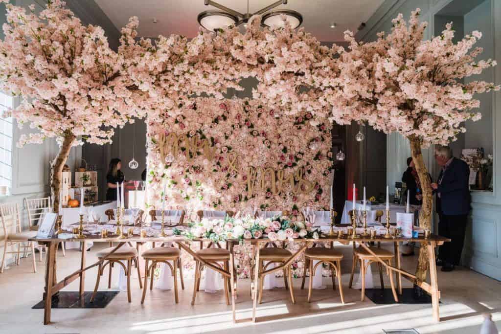 A wedding reception adorned with a rented cherry blossom tree for decoration.