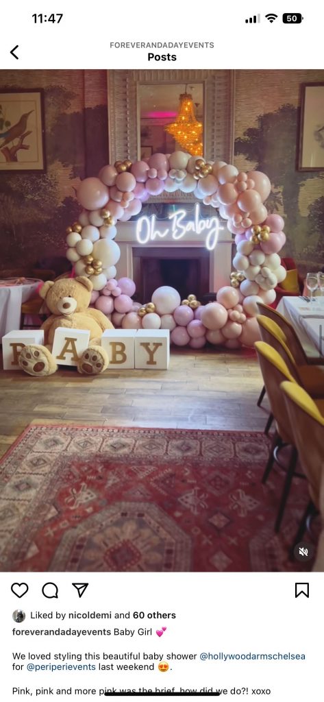 A baby shower with balloons and a teddy bear.
