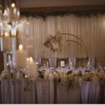 A wedding table set up with candles and flowers.