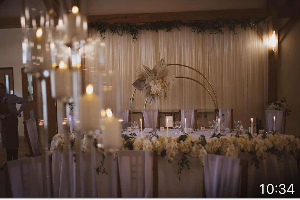 A wedding table set up with candles and flowers.