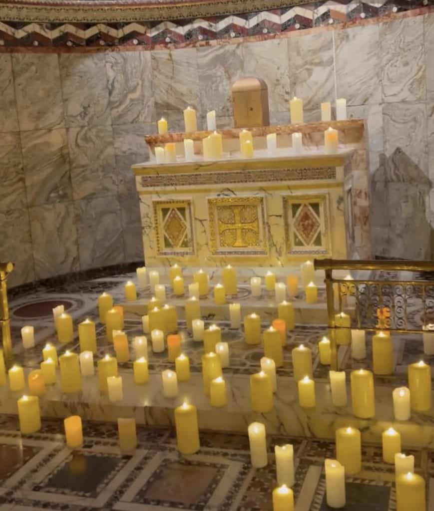 A chapel with candles in the middle of it.