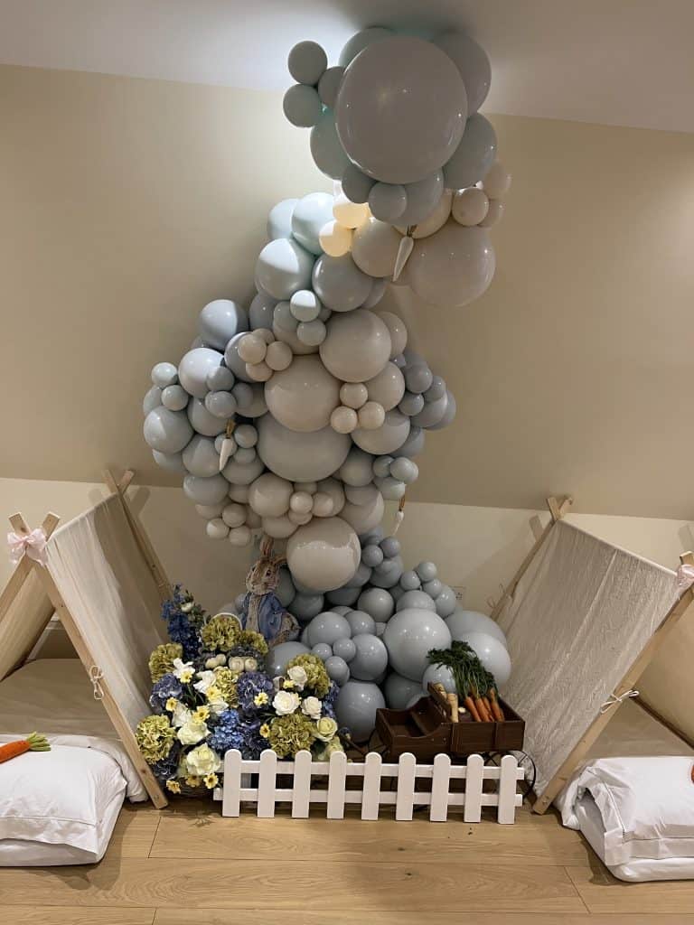 A room decorated with balloons and a bed.