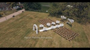 An aerial view of a wedding ceremony in a field.