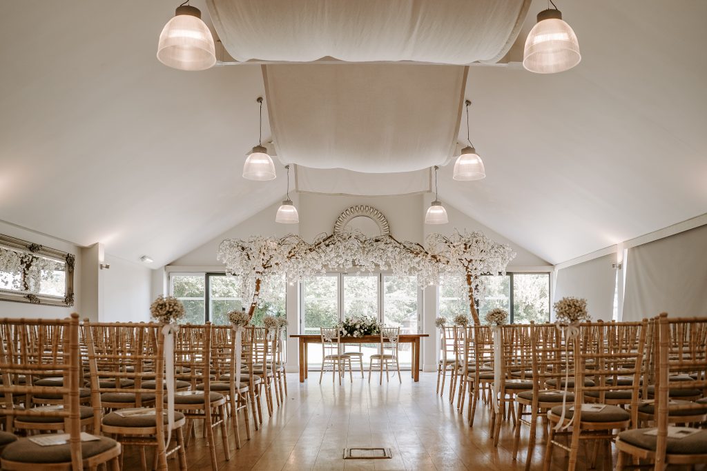 A wedding ceremony set up in a large room.